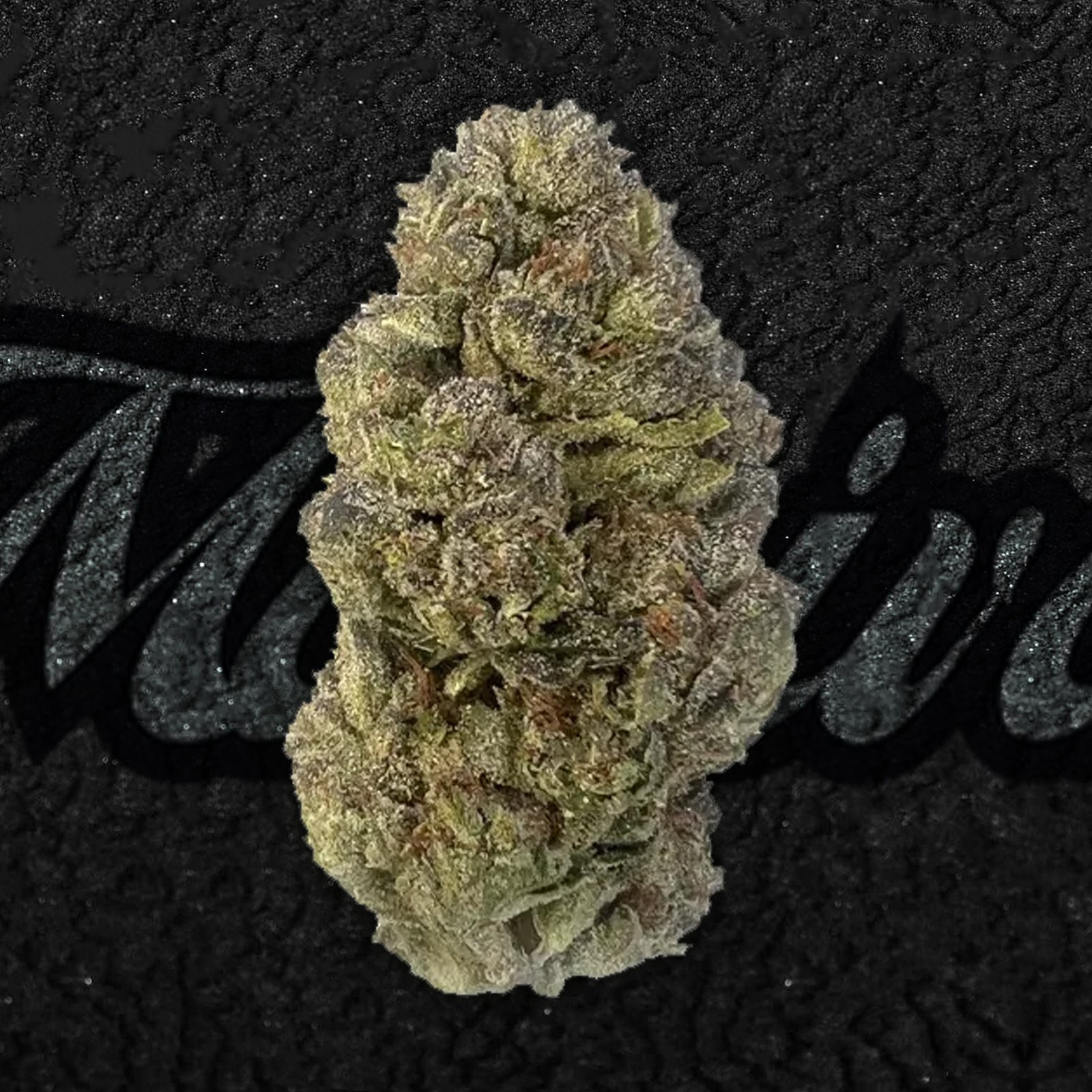 Ice Cream Cake strain flower close-up showing dense, frosty buds with purple accents and orange pistils. Sweet vanilla aroma and heavy indica effects.