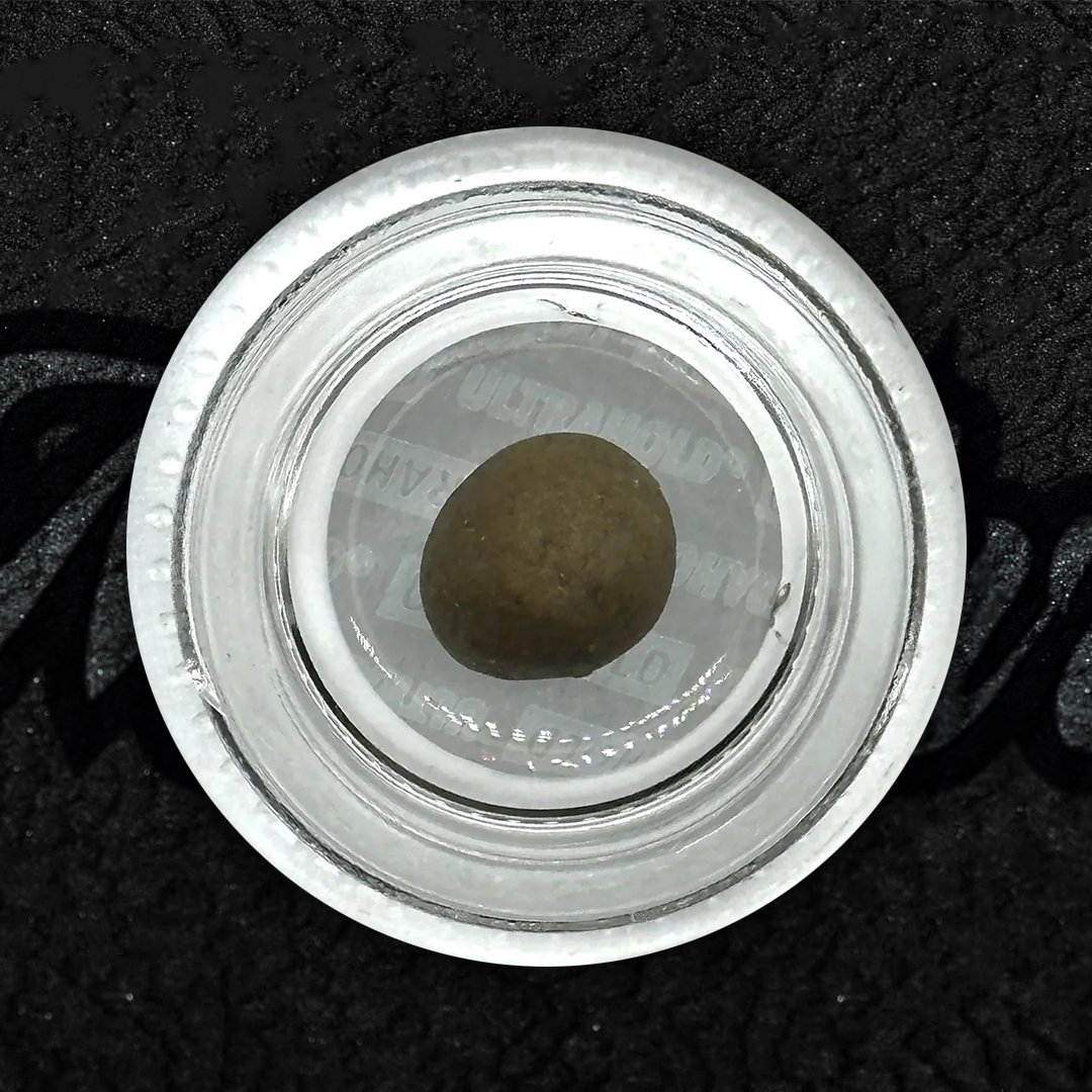 Manali Cream Hash slab, dark exterior with creamy golden interior. Sticky, soft charas-style hash with traditional roots and deep, relaxing effects.
